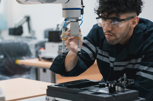 Engineering-student-assembling-a-robotic-arm