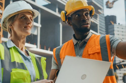 Female and Male Engineers Using a Laptop Computer to Oversee Project Development Plan
