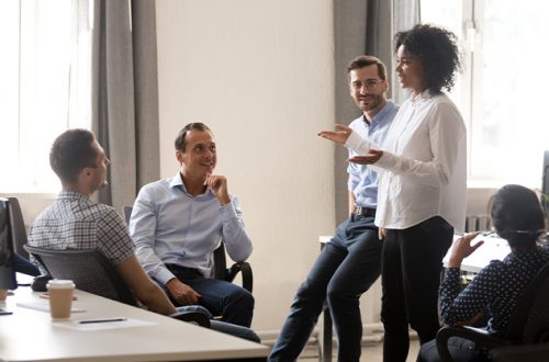 manager-coach-speaking-at-diverse-corporate-group-meeting